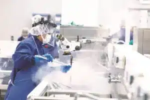 Pharmaceutical waste disposal technician in cleanroom PPE